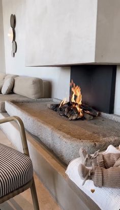 a living room with a fire in the fireplace