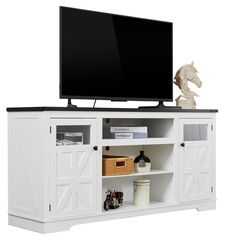 a white entertainment center with sliding doors and a flat screen tv mounted on it's side