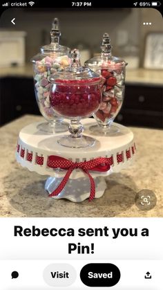 two glass bowls filled with candy on top of a counter