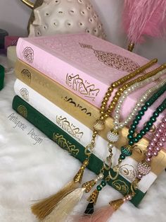 a stack of books with tassels and beads