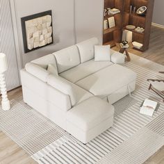 a white couch sitting on top of a rug in a living room