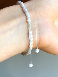 These beautiful bracelets are so dainty, versatile, durable, and adjustable. Easy to put on and off, slide the dangles and macrame closure for the perfect fit. All vintage natural white cats eye stones. Perfect for the beach! Bracelet adjustable 5.5 - 8 inches Comes in gift box Vintage Beaded Bracelet Adjustable Macrame Natural White Cats Eye Stones Beaded Bracelet with Dangles White Beaded Bracelets With Adjustable Length, Adjustable Spiritual Friendship Bracelets With Sliding Knot, Adjustable Braided Bracelets With Sliding Knot And Round Beads, Everyday Friendship Bracelets With Adjustable Cord And Round Beads, Everyday Friendship Bracelets With Adjustable Cord, Spiritual Adjustable Beaded Bracelets With Sliding Knot, Spiritual Macrame Friendship Bracelets With Round Beads, Minimalist Adjustable Braided Beaded Bracelet, Everyday Friendship Bracelets With Round Beads And Adjustable Cord