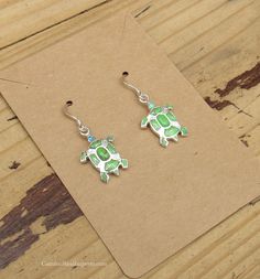 Earrings Turtles Sterling Silver Gaspite and Opal Inlay Measures: 1" (with hooks) Stamped "Sterling" (size and color may vary) Green Adjustable Jewelry With Matching Earrings, Nickel-free Green Sterling Silver Jewelry, Nickel-free Green Jewelry In Sterling Silver, Adjustable Green Sterling Silver Jewelry, Turquoise Jewelry With French Hook For Gift, Green Sterling Silver Earrings With Ear Wire, Adjustable Jewelry With French Hook As A Gift, Hypoallergenic Green Sterling Silver Jewelry, Green Adjustable Earrings With French Hook