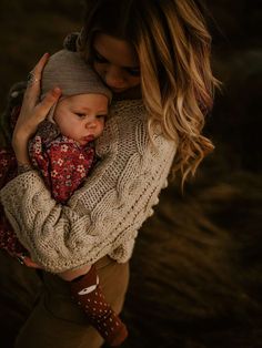 a woman holding a baby in her arms