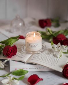 a candle is sitting on top of an open book