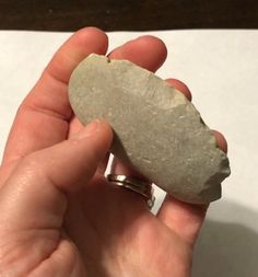 a person holding a rock in their hand