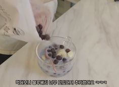 a person pouring ice cream into a cup