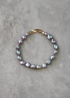 *Enjoy 10% off for a limited time. Use coupon code LIMITED10 at checkout. Does not include bespoke or custom changes. A chic, modern twist on your grandmother's classic pearls, the Rocco pearl bracelet is an elegant accessory featuring lustrous grey pearls, each exuding a contemporary sophistication while paying homage to timeless tradition. Perfect for any occasion, this bracelet effortlessly transitions from daytime grace to evening glamour. * DETAILS * > Designed and handmade in Australia > G Elegant Gray Bracelets As Gift, Elegant Gray Bracelet As Gift, Elegant Gray Bracelets For Gift, Elegant Gray Bracelet For Gift, Mother Of The Bride Gift, Grey Wedding, Freshwater Pearl Bracelet, Wedding Jewelry Bracelets, Bride Gift