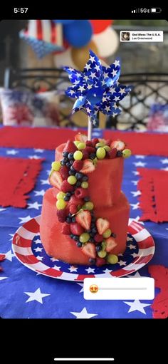 a red, white and blue cake with berries on top