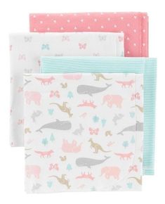 three napkins with dinosaurs on them and hearts in pink, blue, and white