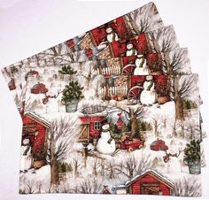 three napkins with snowmen and farm scenes on them