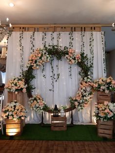 an arrangement of flowers and greenery decorates the backdrop for a wedding or reception