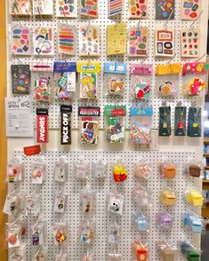 there are many items on the pegboard in this store that is organized with plastic bags and magnets