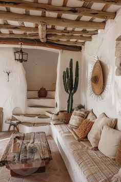 a living room filled with lots of furniture next to a stone wall covered in plants