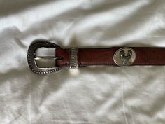 Vintage Brown Leather Belt with Silver Buckle & Deer Details (1990s) By: John Rich & Bros Woolrich Material: Silver & Leather MEASUREMENTS Length: 45.5" Width: 1.25" CONDITION NOTE: The belt's silver features are tarnished and need polishing. Feel free to message me with further inquiries! All sales are final, please message me with any questions/ concerns prior to purchase. Clean And Press, Vintage Leather Belts, Brown Leather Belt, Suspender Belt, Leather Vest, Vintage Brown, Suspenders, Vintage Leather, Vera Bradley