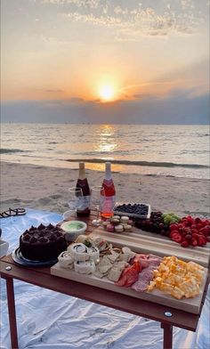 a table with food on it at the beach