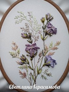 a close up of a cross stitch pattern with flowers