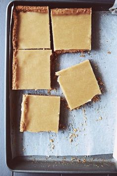 four squares of peanut butter on a baking sheet