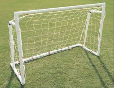 a white soccer goal with red balls on it