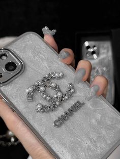 a woman's hand holding an iphone case with the word love spelled on it