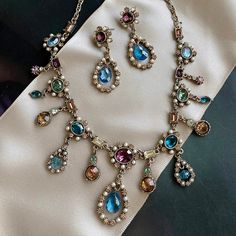 This French 1700s inspired necklace features vintage cut crystal stones in exotic tourmaline shades of blues, amethyst, champagne, green and seed pearls. The stones are in perfect, never used condition, acquired when I first designed and produced the necklace for the Victoria & Albert Museum. Each of the elements is exquisitely sculptured and joined to create a fluid collar in the Regency style. It is titled Juliette for the woman who inspired it -- Juliette Recamier -- whose famed Paris salon w Vintage French Jewelry, Bridgerton Jewelry, Regency Jewelry, French Regency, Vintage Statement Jewelry, Jeweled Collar, 18th Century Costume, Antique Costume Jewelry, Locket Bracelet