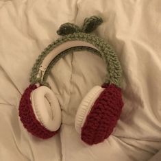 a pair of headphones laying on top of a bed