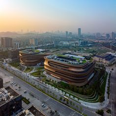 an aerial view of a large building in the middle of a city with lots of tall buildings