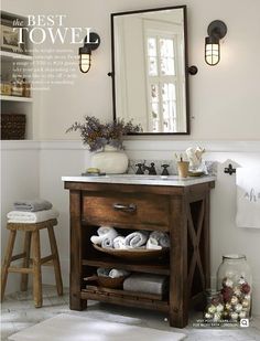 a bathroom with a sink, mirror and stools