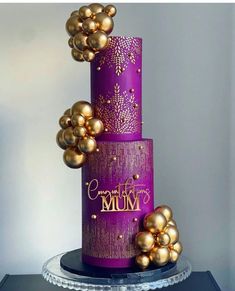 a purple cake with gold decorations on top