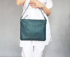 "Great small green leather crossbody bag to brighten up any outfit!  This shoulder purse is large enough to hold your daily essentials, but very lightweight and comfortable. I've crafted it of soft natural leather in petroleum green color. It features one front pocket with decorative lacing, cotton lining with open leather pocket and zipper closure.  The size of the bag: height - 10\" / 26 cm width - 12\" / 30 cm strap lenght - 40\" / 102 cm The bag will be sent by registered, priority mail." Everyday Green Pouch Shoulder Bag, Green Crossbody Hobo Bag For Daily Use, Versatile Green Crossbody Hobo Bag, Green Leather Satchel Shoulder Bag, Green Everyday Satchel With Zipper Pocket, Everyday Green Satchel With Zipper Pocket, Green Leather Shoulder Bag For Mobile Phone, Green Soft Leather Handheld Shoulder Bag, Green Handheld Shoulder Bag In Soft Leather