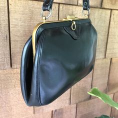 Beautiful 1950s vintage Bienen-Davis handbag. Structured and lady like with a top handle and brass details. Three interior sections and the original double sided mirror with pouch. Classic American luxury -- since 1931.  9x6x2. Excellent condition.  A few minor scuffs and a little wear on handle.  See pics. Vintage Top Handle Evening Bag For Formal Occasions, Vintage Formal Evening Bag With Top Handle, Vintage Black Rectangular Evening Bag, Retro Evening Bag With Brass Hardware, Vintage Evening Bags With Brass Hardware, Retro Evening Bags With Brass Hardware, Vintage Formal Bag With Brass Hardware, Vintage Evening Bag With Detachable Strap And Top Handle, Vintage Formal Shoulder Bag With Detachable Strap