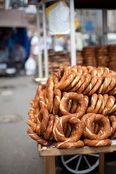 a pile of pretzels sitting on top of a wooden cart