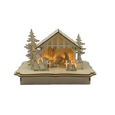 an illuminated nativity scene in the shape of a house with christmas trees and animals