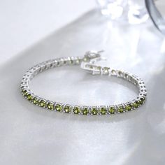 MATERIALS: Made with white gold plated high polished 925 sterling silver and Created Green Peridot stones. Made to last a lifetime, strong and durable! All the metals we use are lead free, nickel free and hypoallergenic. BIRTHDAY BRACELET: Peridot is known as a a stone of happy, light-hearted vibes and the perfect companion to lead you on a path of sunshine. Peridot is a sign that it's time to feel good, a simple wish and our divine birthright. MEASUREMENTS: Tennis Bracelet width: 4mm. Chain len Gifts For Mother In Law, Happy Light, Costume Wedding, Gifts For Aunt, Wife Gifts, Birthday Bracelet, Mother In Law Gifts, Peridot Stone, In Law Gifts