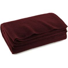 the maroon blanket is folded on top of each other