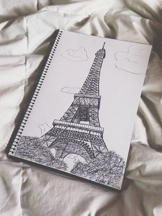 a drawing of the eiffel tower on a bed