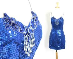 Cute short blue sequin dress with spaghetti straps. Bedazzled throughout and great for parties and fun.Label: UnknownMaterials: UnknownCare: Spot CleanSize: UnknownBest fits a size medium to largeBust:  34 - 36"Waist: 28"Hips: 36"Length: 33"This garment is in excellent vintage condition. Sequin Dress Blue, Blue Club Dress, Sequin Bodysuit, Blue Sequin Dress, Marine Uniform, Sequin Blouse, Party Fits, Cute Shorts, Teen Fashion Outfits