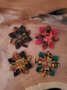 three different types of hair clips sitting on top of a wooden table