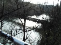 a view from the top of a hill looking down at a river