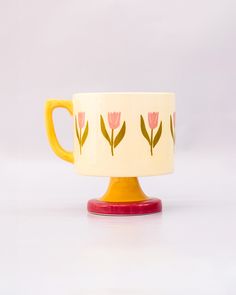 side view of top view of cream 10 oz ceramic mug with yellow handle, pink pedestal base and pink tulip print Pretty Ceramic Mugs, Ceramic Painted Mug, 60s Ceramics, Tulip Mug, Scandinavian Home Decor, Clay Techniques, Colorful Pottery, Color Me Mine, Tulip Painting