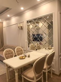 a dining room table and chairs in front of a mirrored wall with an open closet behind it