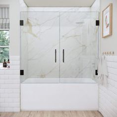 a bathroom with white walls and wood flooring has a glass shower door that is open to the outside