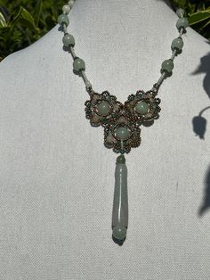 This beautifully executed necklace is made of stands are jade beads interspersed with glass beads for a visual effect. They connect in the front in a floral cluster and a jade medallion tops it off. This is a one of a kind, necklace and we think it is truly special. This floral inspired necklace from a husband and wife team that take beads, jade and present them in beautiful novel ways. It's handmade, and we procured the only one they had. Details: Button clasp. Size: Length of strand (from flow Inspired Necklace, Floral Pendant, Jade Beads, Art Deco Inspired, Green Jade, Husband And Wife, Green Bead, Jade Green, Crystal Beads