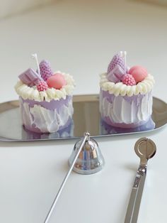 two small cakes on a plate with a pair of keys