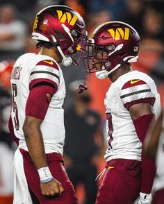 two football players standing next to each other