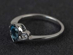 Welcome to my shop, you can find many beautiful gemstone jewelry here, and you also can ask for customized service. Main Stone: London blue topaz, pear cut, measures 5*7mm, weight about 0.95 carats.Accent Stones: czMetal: 925 sterling silver plated with rhodium. I also can provide metal options such as 14k solid yellow/white/rose goldSetting: bezel settingmore rings: https://www.etsy.com/shop/XCjewelryStudio?ref=hdr_shop_menuIt's a perfect gift for the person who was born in November (Birthstone Pear-shaped Topaz Promise Ring, Elegant Topaz Teardrop Rings, Fine Jewelry Blue Topaz Teardrop Rings, Three Stone Pear-shaped Jewelry Gift, Three Stone Topaz Promise Ring, Blue Topaz Three Stone Promise Ring, Elegant Pear-shaped Topaz Ring In Sterling Silver, Silver Crystal Promise Ring, Pear-shaped, Elegant Silver Pear-shaped Topaz Ring