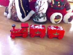 a group of christmas toys sitting on top of a wooden floor next to each other