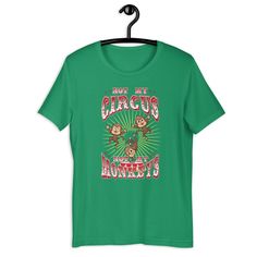 a green t - shirt with monkeys on it that says, not my circus monkeyies are