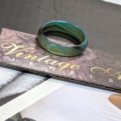 a green ring sitting on top of a book