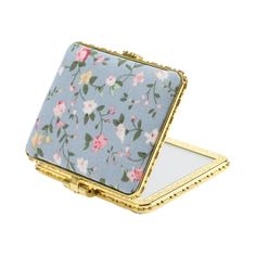 a small blue and pink flowered box with gold trim